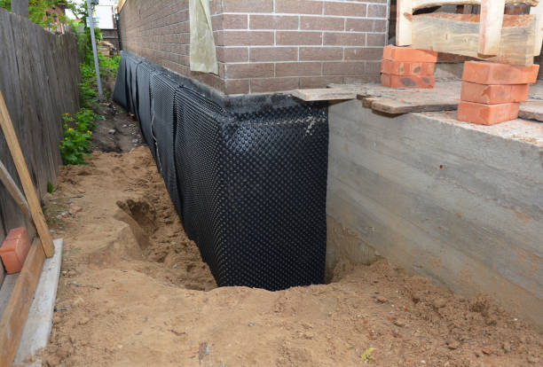 Happy homeowners after waterproofing job in Belmont